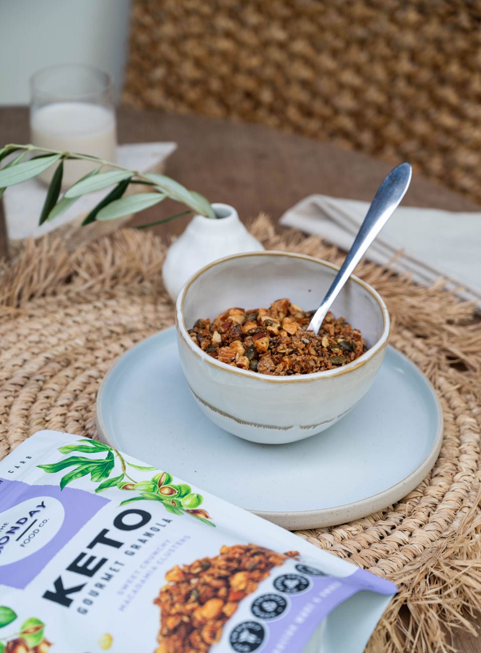 Keto Gourmet Granola - Sweet Crunchy Macadamia Clusters - 300g by The Monday Food Co in bowl with spoon and packaging nearby