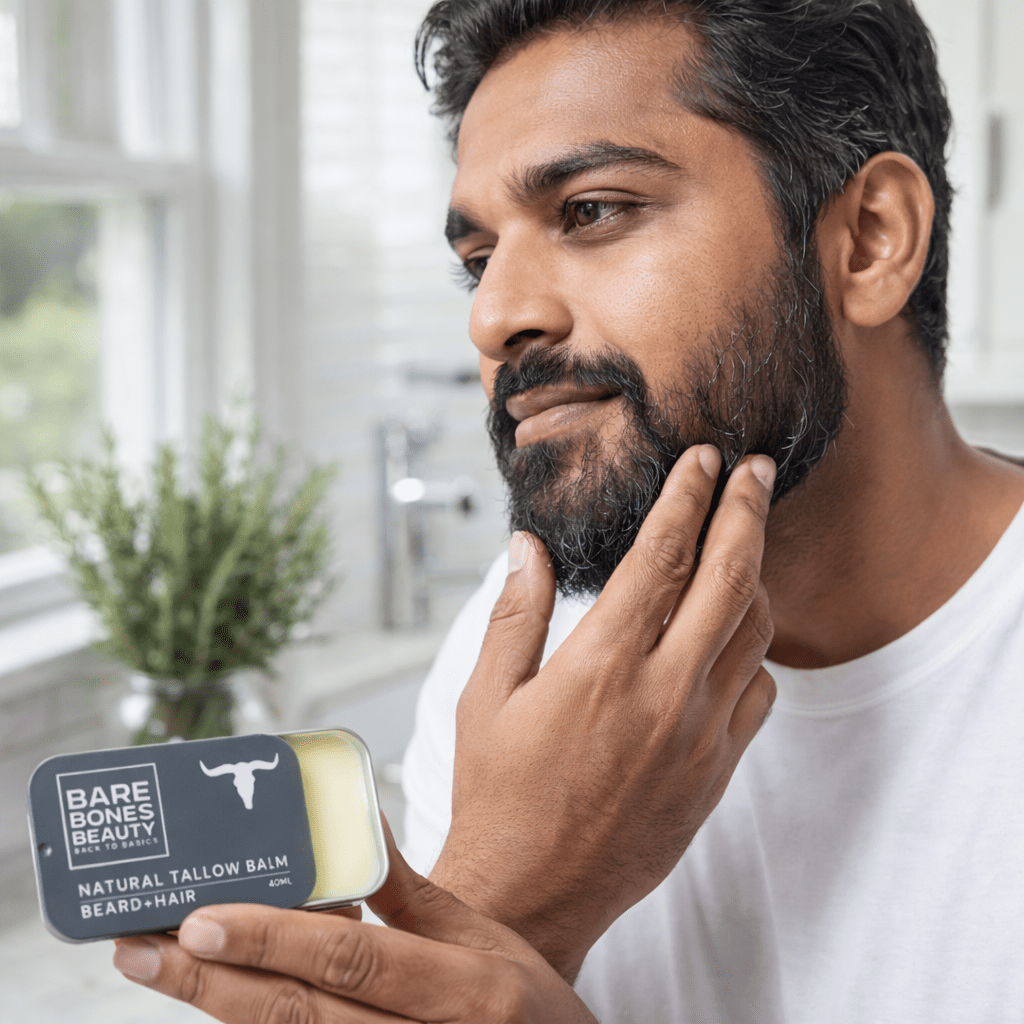 Man applying Bare Bones Beauty Beard Tallow Balm - 40ml to his beard in a bright natural light setting