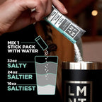 Hand pouring LMNT Raw Unflavoured Electrolyte Mix - 30 Sticks into a cup with graphic showing mixing instructions for various saltiness levels by LMNT.