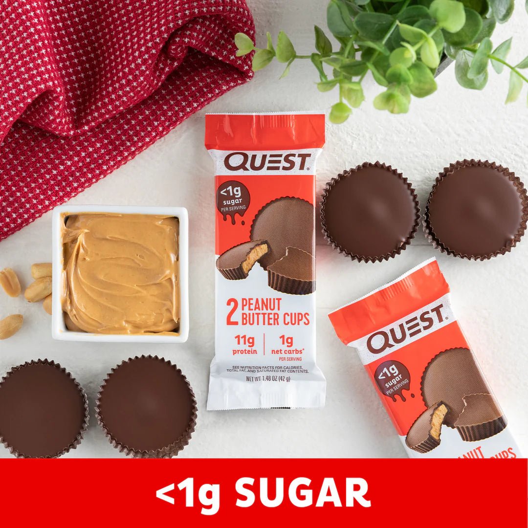 Peanut Butter Cups x 12 by Quest Nutrition with chocolate cups, peanut butter spread, and green plant in background