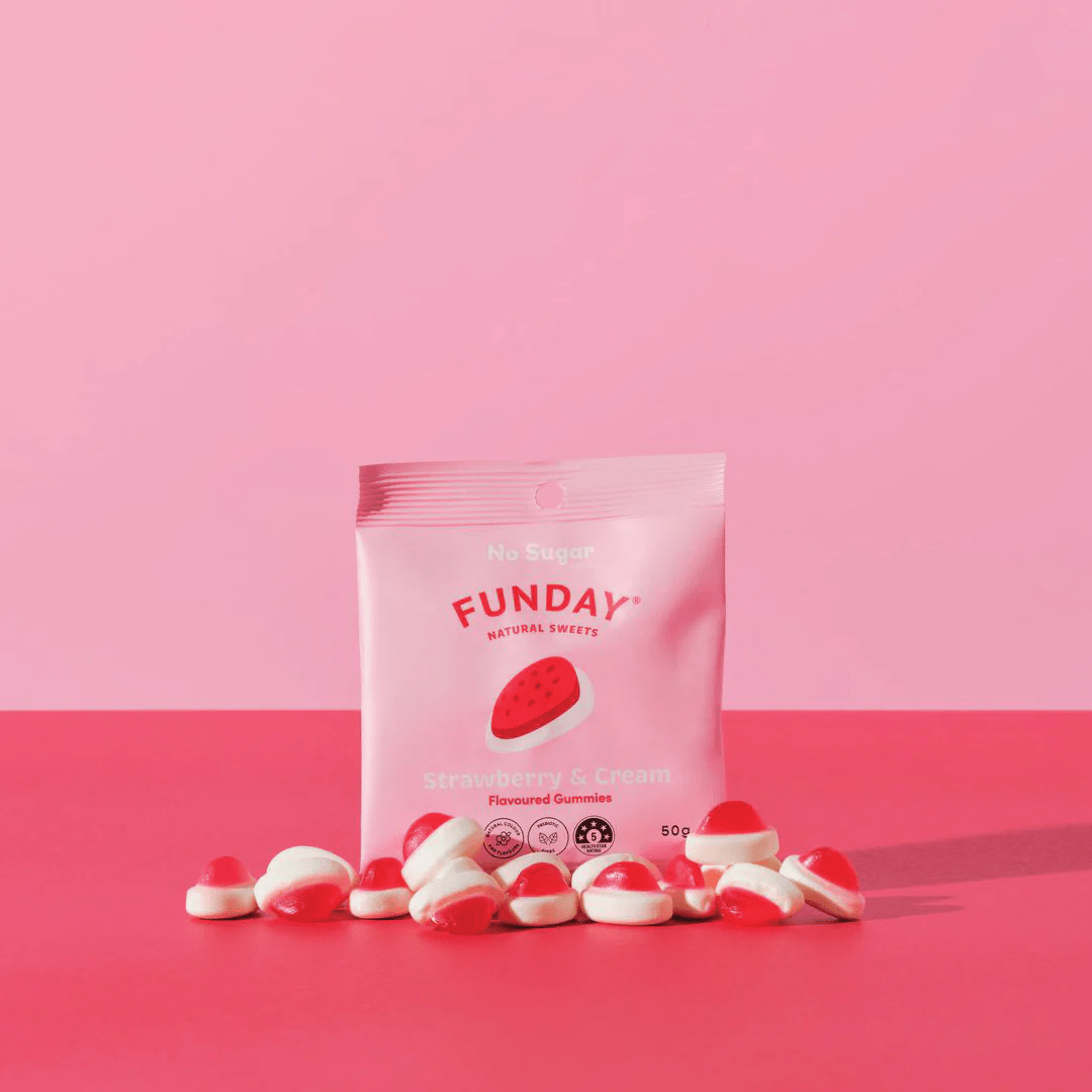 Strawberries & Cream Gummies - 50g x 12 by Funday with pink packaging and red and white gummy candies on pink background